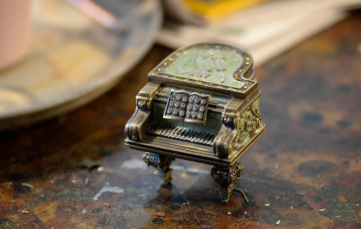 A piano figurine is placed on a coffee table in the home of Dzidra Reimanis, a 92-year-old piano teachers, on Thursday, February 6, 2020. Reimanis has been teaching piano in Charlotte for more than 50 years