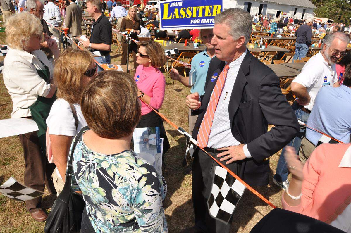 Mayoral candidate John Lassiter talks to people at the 80th Mallard Creek BBQ at Mallard Creek Presbyterian Church in 2009. 
