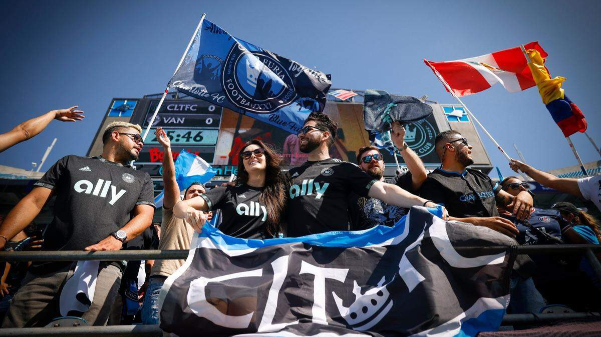 Charlotte FC fans cheer in the stands during warm up before a 2022 game between Charlotte FC and the Vancouver Whitecaps at Bank of America Stadium.