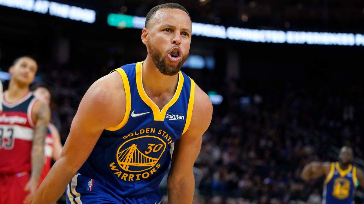 Golden State Warriors guard Stephen Curry reacts after scoring and being fouled during the second half of a game against the Washington Wizards in San Francisco on March 14, 2022.