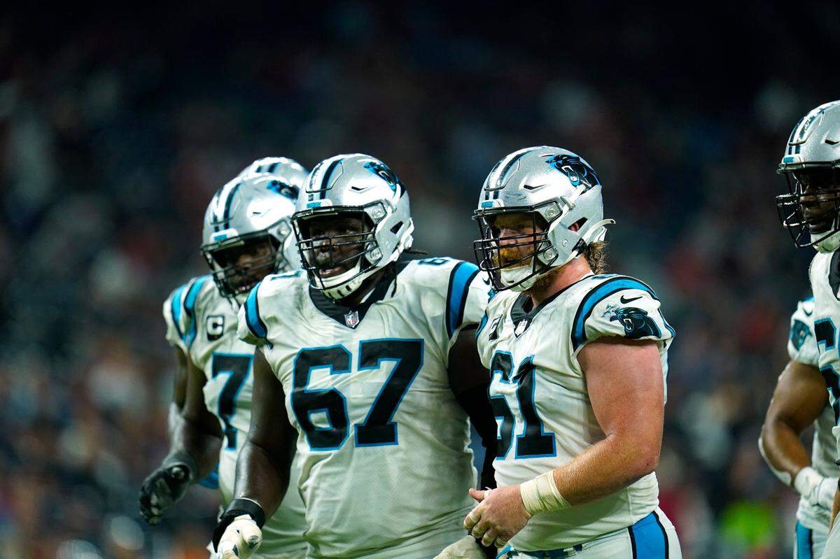 Carolina Panthers offensive lineman including Matt Paradis (61) and John Miller (67) break the huddle during an NFL football game against the Houston Texans, Thursday, Sept. 23, 2021, in Houston. (AP Photo/Matt Patterson)