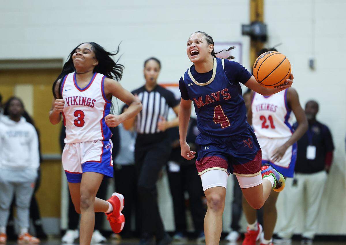 Mallard Creek Mavericks Kiara Anderson, right, smiles as she drives past North Mecklenburg Vikings Zion Pimentel at Julius L. Chambers High School in Charlotte, N.C., on Friday, February 21, 2025.