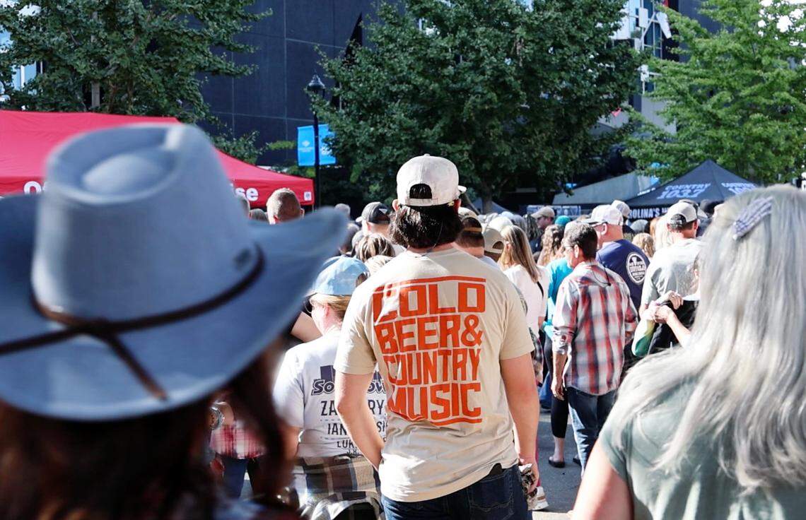 Crowds of people walk around Bank of America Stadium as they wait for Concert for Carolina in Charlotte on Saturday.