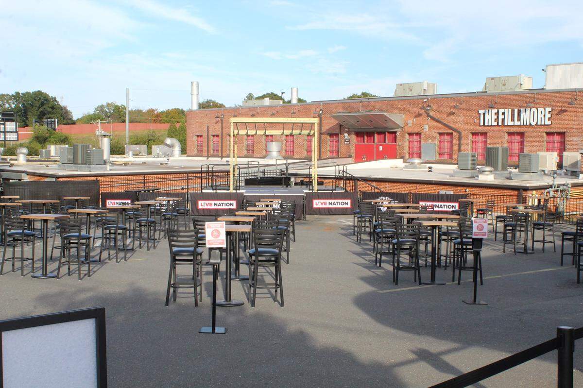 The Fillmore Charlotte live music venue last month launched Live in the Lot with comedy and tribute bands performing outdoors amid the COVID-19 pandemic. Seating is set up in the parking lot.