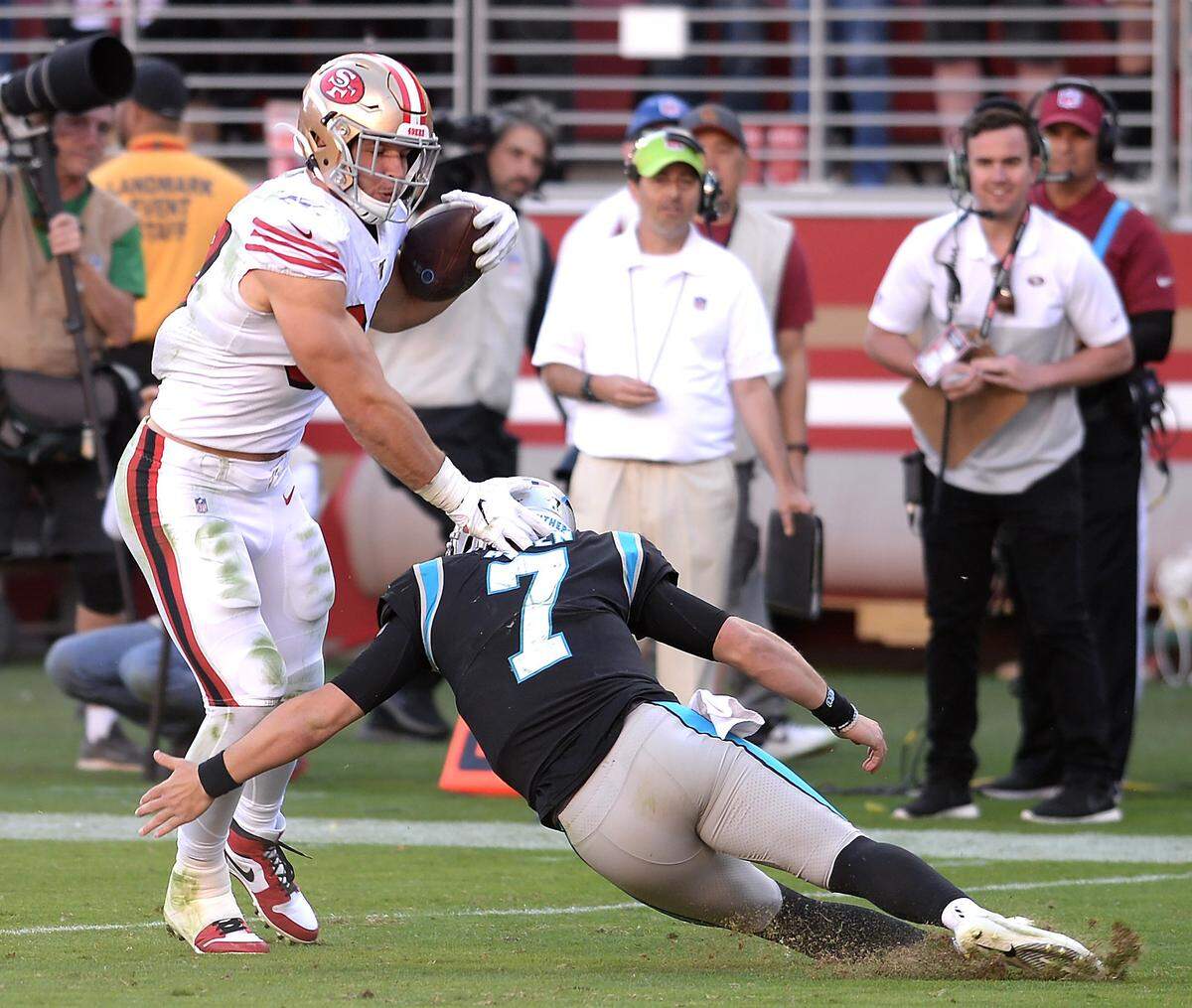 San Francisco 49ers defensive lineman Nick Bosa, left, avoids Kyle Allen after intercepting Allen’s pass Sunday. Allen hadn’t thrown a single interception in his first five NFL starts, but he threw three Sunday. Allen will start his sixth straight game Sunday at home against Tennessee.