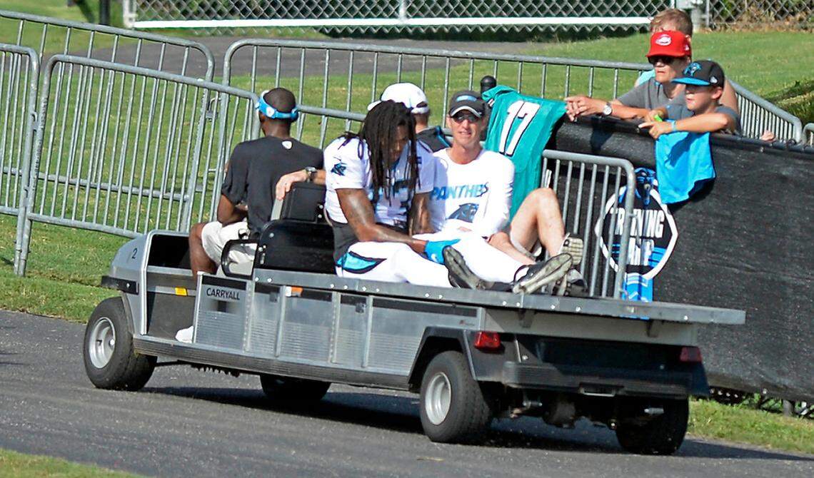 Carolina Panthers’ Kelvin Benjamin (13) holds his leg as he is carted off the field, as head athletic trainer Ryan Vermillion accompanies him, during a scrimmage against the Miami Dolphins during Carolina Panthers Training Camp at Wofford College in Spartanburg, SC on Wednesday, August 19, 2015. Benjamin’s ACL tear in a non-contact drill meant that he would be lost for the entire 2015 season.