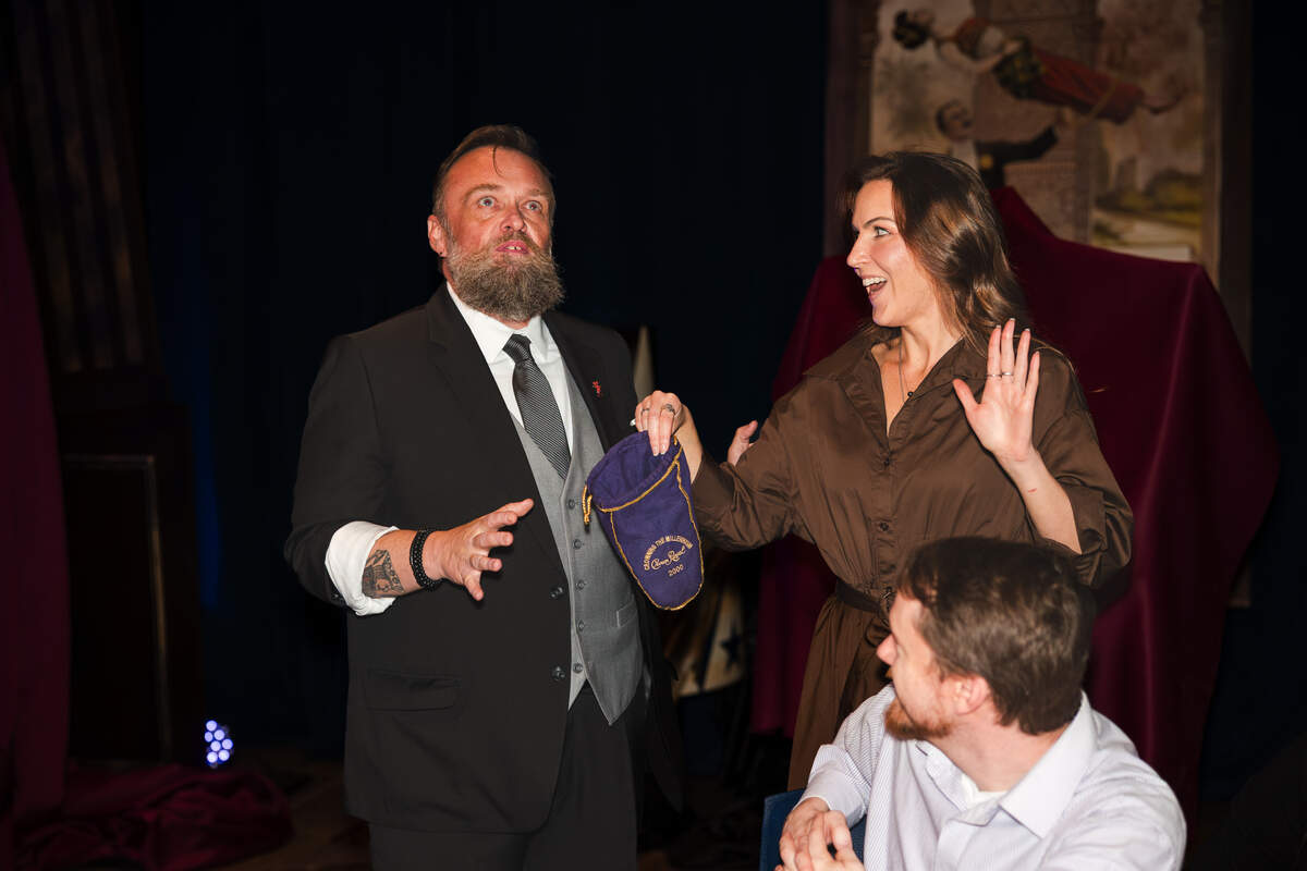 Magician Doc Docherty, left, enlists an audience member in performing a trick. The Lincolnton native has spent the past 25 years working as a magician.