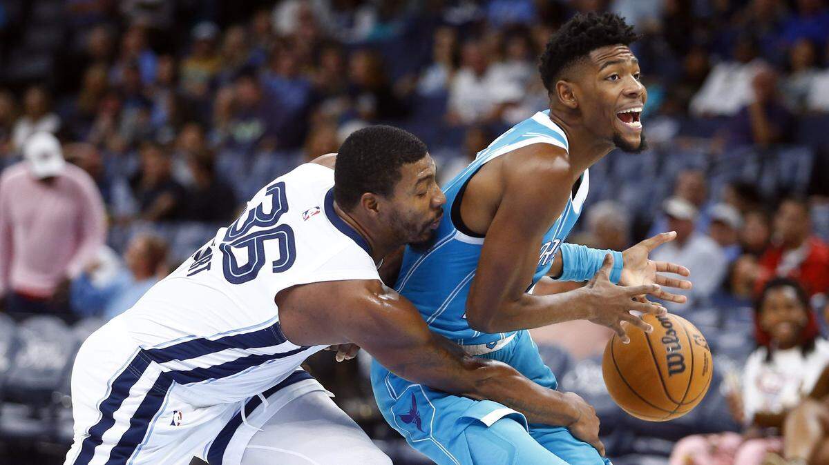 Memphis Grizzlies guard Marcus Smart (36) knocks the ball away from Charlotte Hornets forward Brandon Miller (24) as he drives to the basket during the first half at FedExForum.