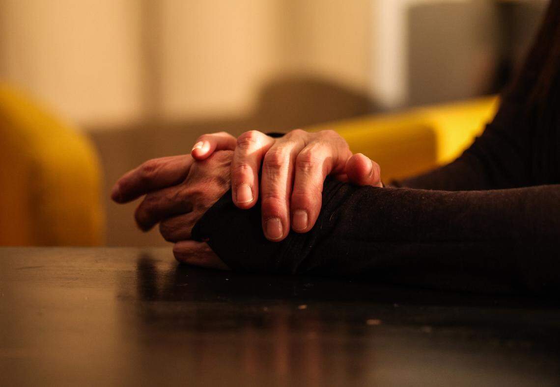 Amparo’s clasps their hands while speaking about their undocumented status at Camino Center in Charlotte, NC on Tuesday, January 14, 2025.