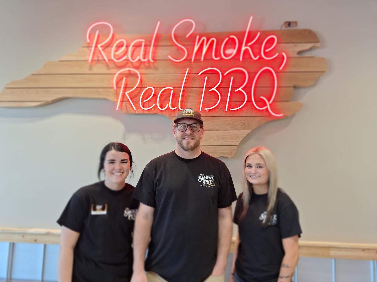 Shown at the Smoke Pit barbecue restaurant in Mooresville on Tuesday, March 31, 2026, are, from left, front-of-house employee Miley Griggs, social media manager Justin Sides and front-of-house employee Skylar Hager.