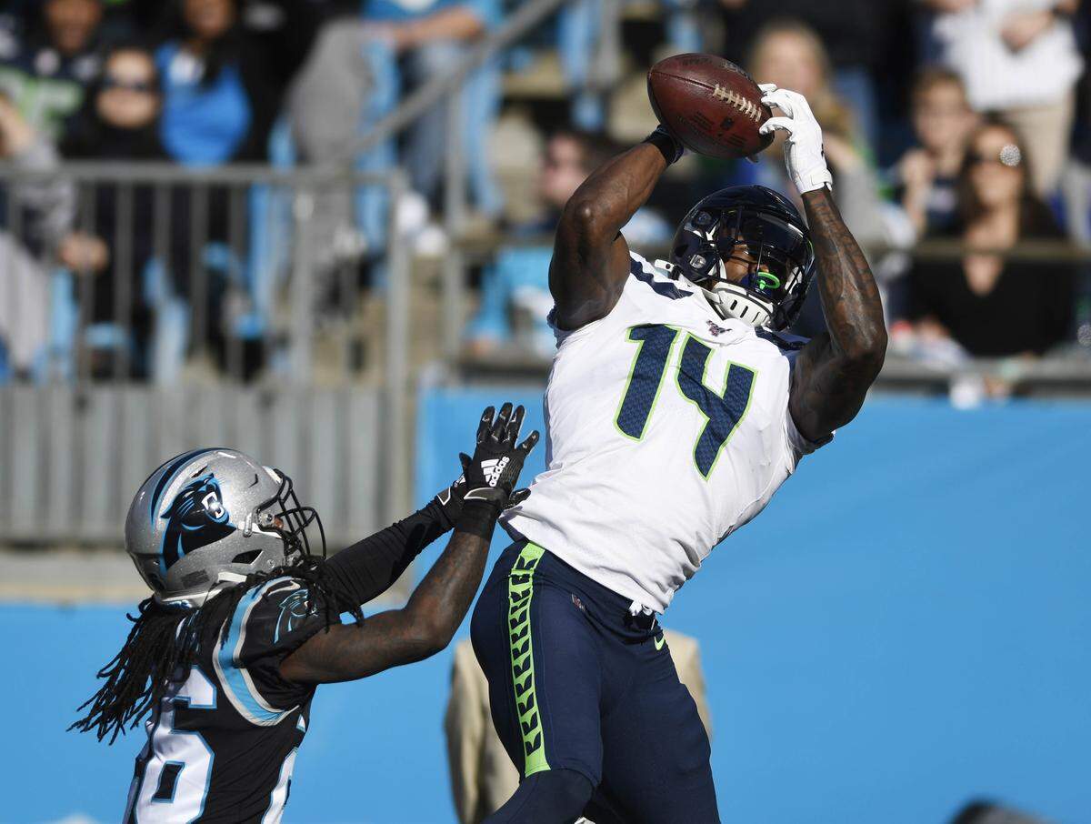 Seattle wide receiver D.K. Metcalf (14) reaches up for a touchdown reception past Panthers cornerback Donte Jackson Sunday. The Seahawks scored touchdowns on each of their first three possessions.