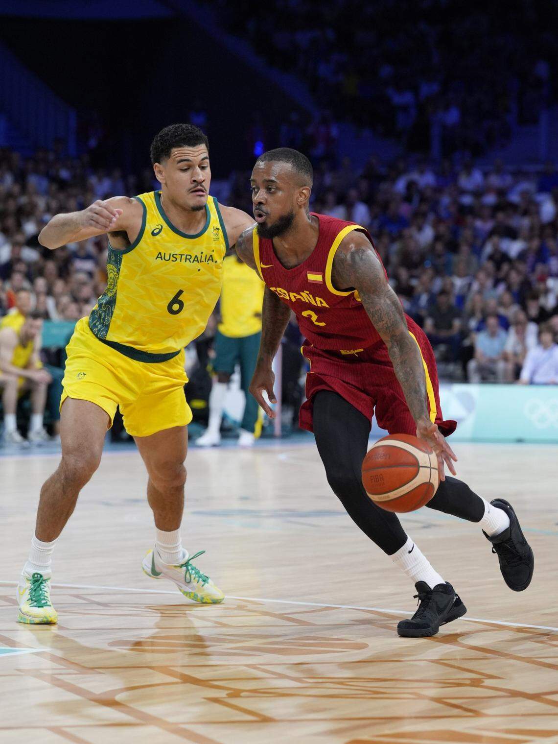 Spain guard Lorenzo Brown (2) drives past Australia small forward Josh Green (6) in men’s Group A play during the Paris 2024 Olympic Summer Games at Stade Pierre-Mauroy.