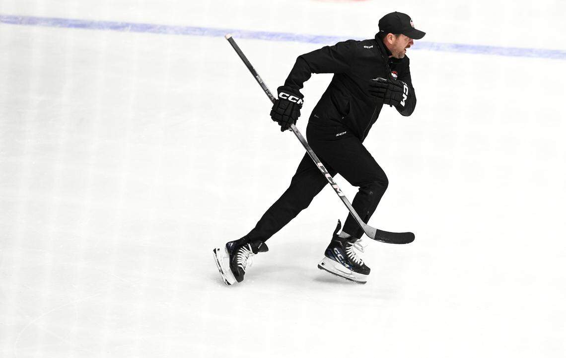 Charlotte Checkers head coach Geordie Kinnear breaks across the ice as he demonstrates how he wants the players to make a cut during practice at Bojangles Coliseum in Charlotte, NC on Tuesday, October 15, 2024. The Checkers will play their first two home games against the Cleveland Monsters on Friday, October 18th and Saturday, October 19th.