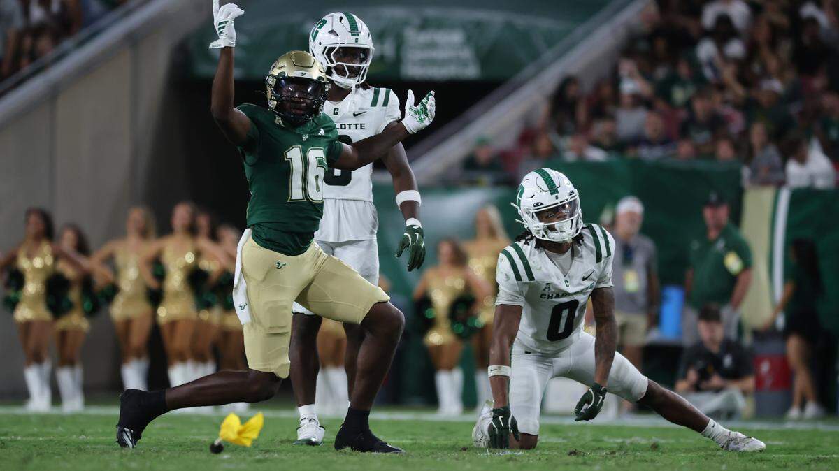 Charlotte 49ers defensive back Randy Franklin (0) gets called for pass interference on South Florida Bulls wide receiver Jeremiah Koger (16) during the second quarter at Raymond James Stadium. 