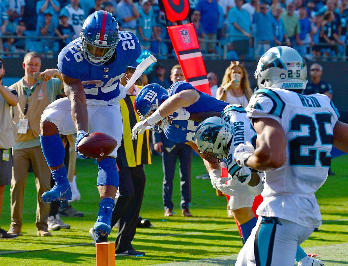New York Giants running back Saquon Barkley somehow broke the plane with the football while twisting his body on the side of the end zone as the Giants tried to mount a comeback. The Panthers defeated the Giants 33-31.