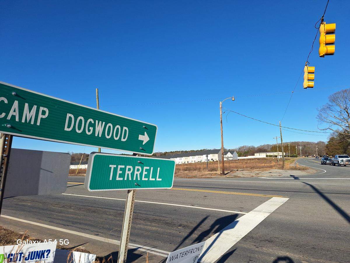 The weed-filled acreage where Terrell Town Center Area 2 will be built is pictured in the distance from across N.C. 150 in Terrell NC on Tuesday, Jan. 14, 2025.
