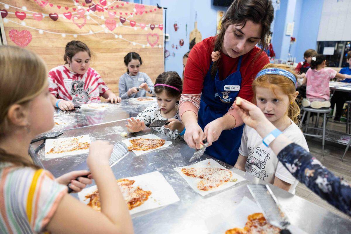 Kids learn to make pizza during a cooking class at Flour Power in Charlotte.
