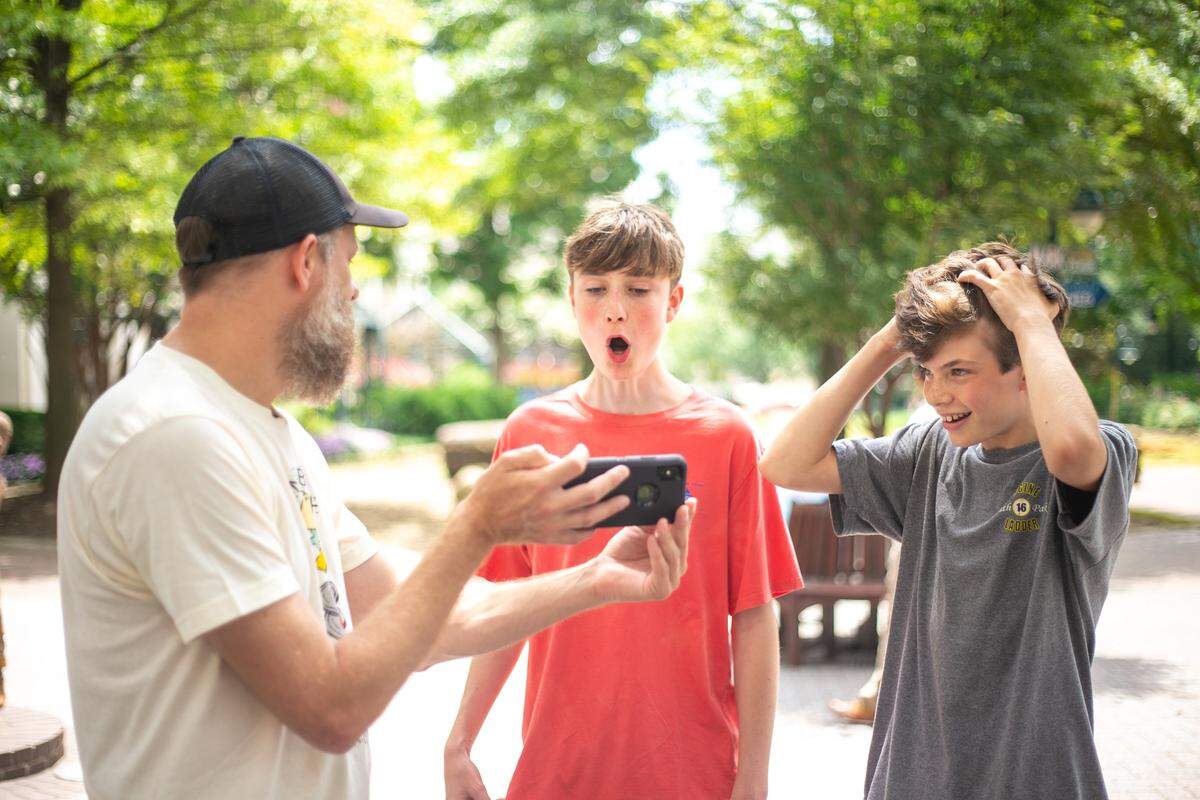John Austin, left, has a talent of taking phrases and saying the words in reverse, gets a reaction from Henry Stuart, center, 14, and Tommy Hawthorne, 13, after saying a phrase they requested in Charlotte on Sunday, July 10, 2019.