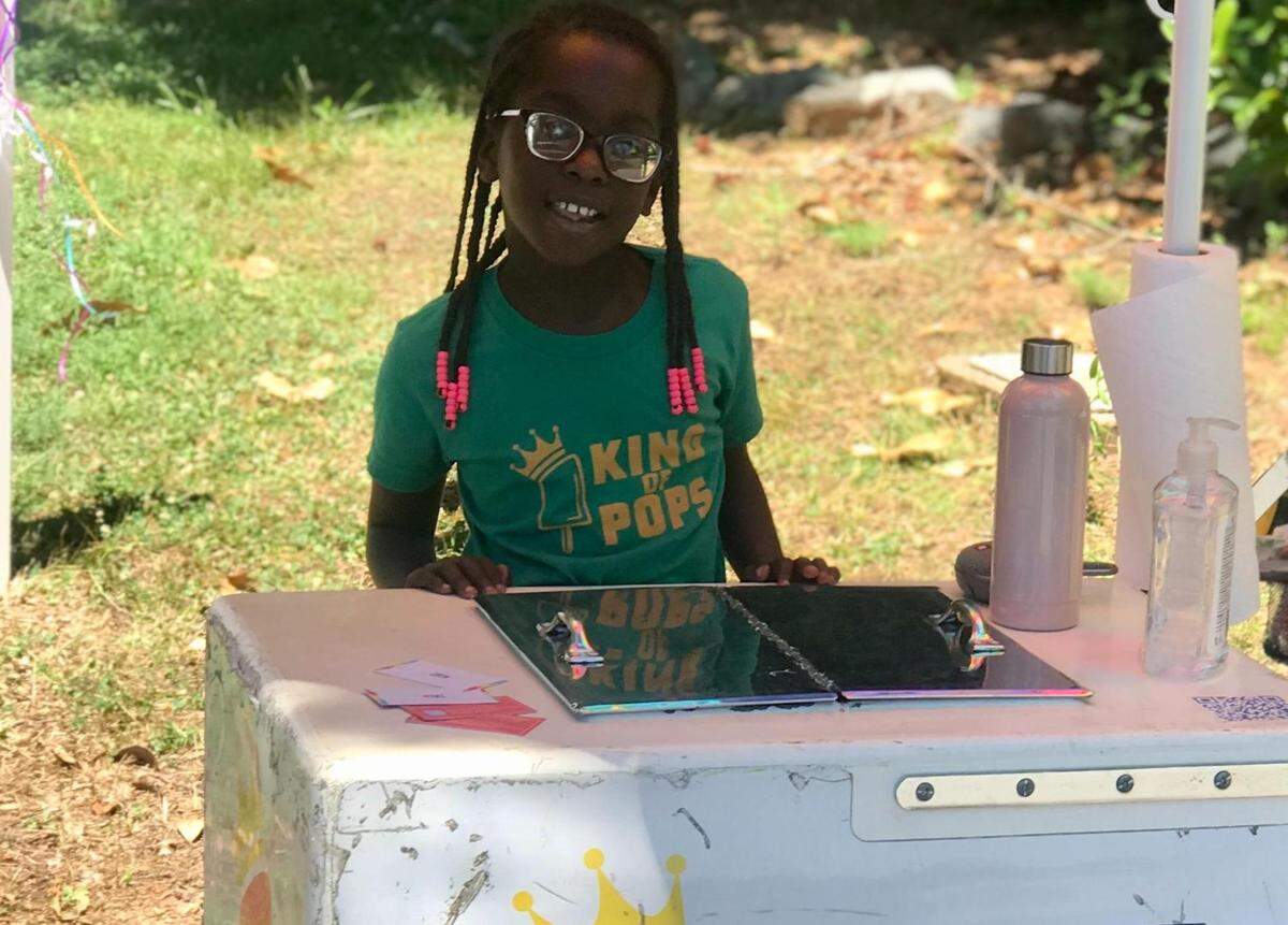 Nia Mwangi, 7, sometimes helps her parents, Chris and Samantha Mwangi, serve popsicles at Charlotte-area events.
