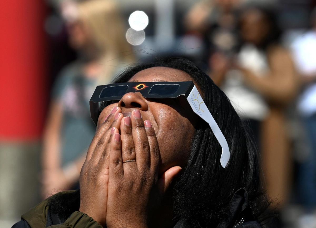 Jerisbel Silva reacts to the solar eclipse during a viewing party in Charlotte.