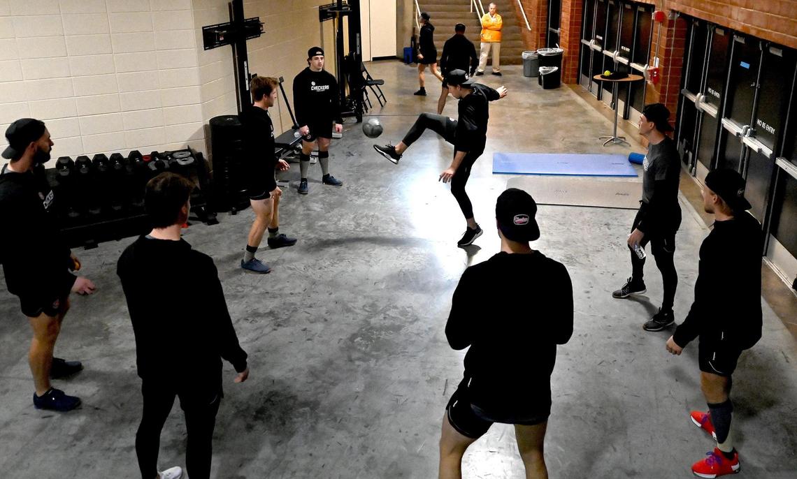 Members of the Charlotte Checkers loosen up and enjoy a game of sewer ball in a hallway at Bojangles Coliseum in Charlotte, NC on Friday, October 18, 2024. The Charlotte Checkers hosted the Cleveland Monsters in the home opener.