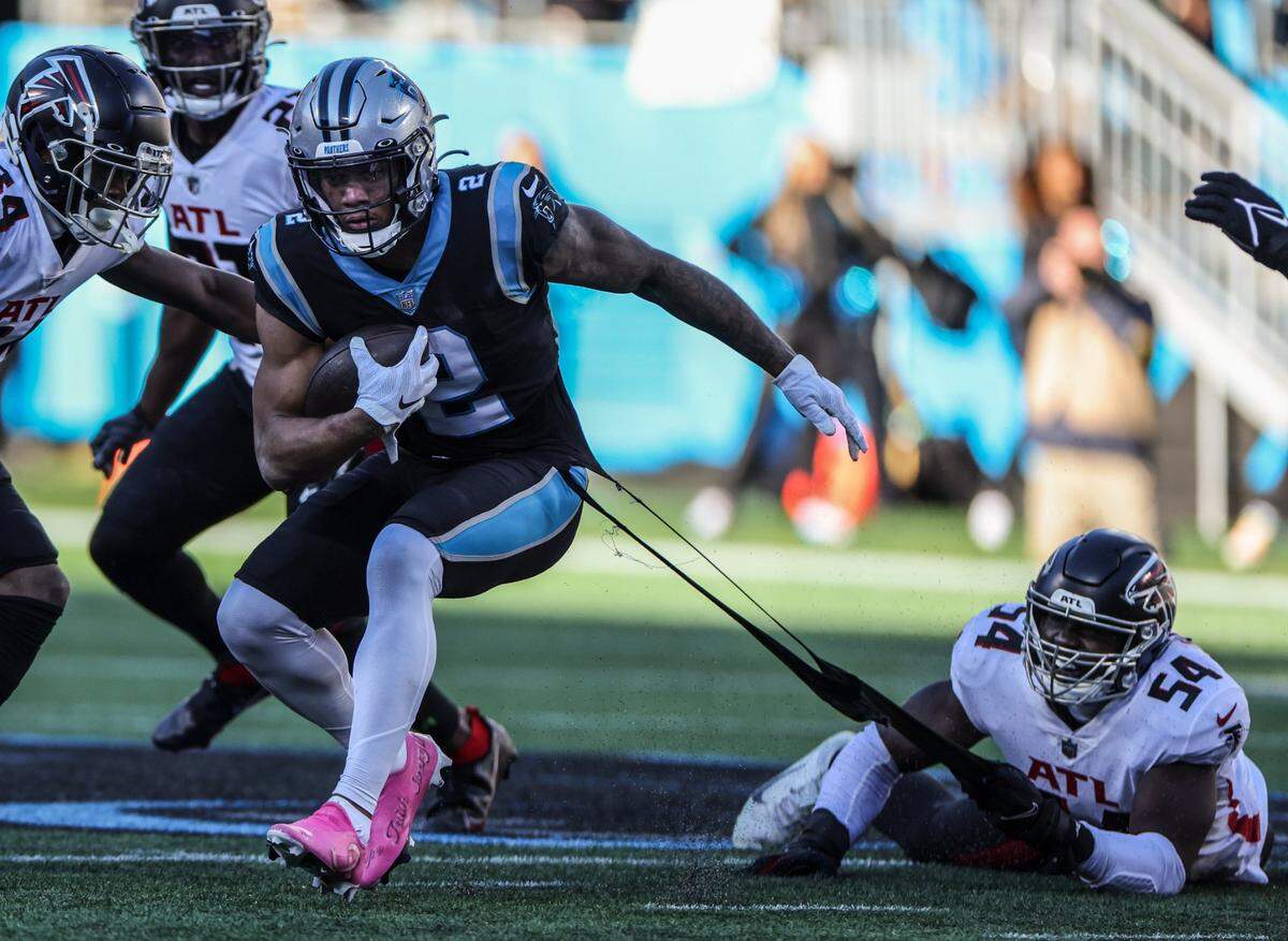Carolina Panthers wide receiver D.J. Moore, left, has his jersey ripped by Atlanta Falcons defender Foyesade Oluokon at Bank of America Stadium in Charlotte on Sunday. The Panthers lost, 29-21.