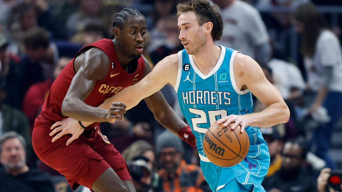 Charlotte Hornets forward Gordon Hayward (20) drives against Cleveland Cavaliers guard Caris LeVert during the first half of an NBA basketball game Friday, Nov. 18, 2022, in Cleveland. (AP Photo/Ron Schwane)