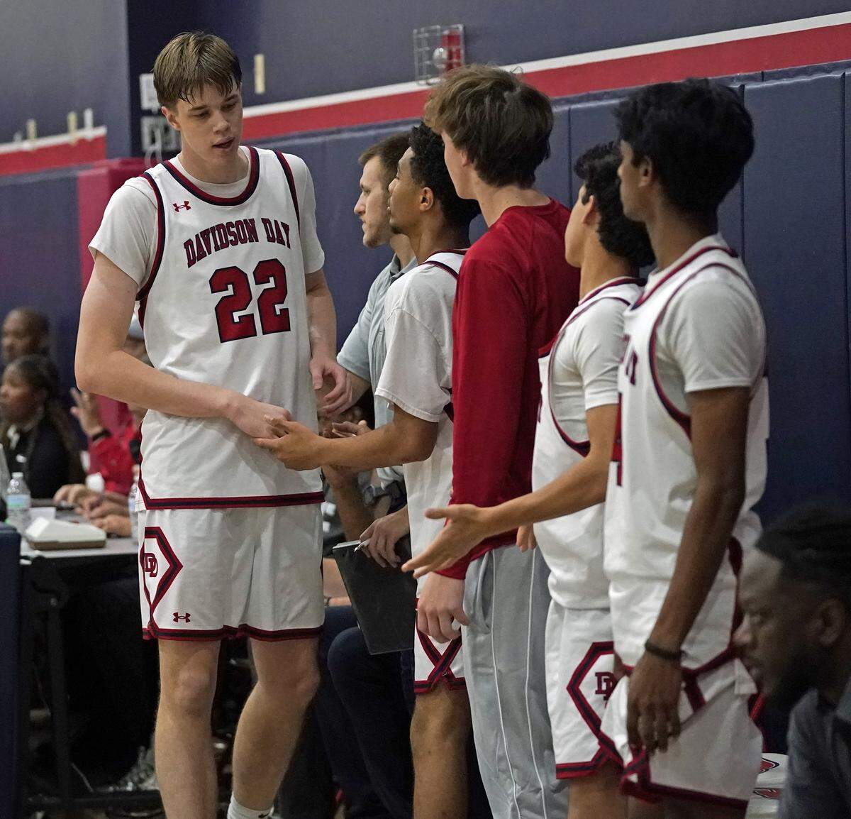Davidson Day's Will Stevens, left, is greeted by teammates as he goes to the bench during the second half of the Phenom Hoops Classic high school boys basketball game against Christ School on Satuirday, Nov. 15, 2025, in Davidson, N.C. (Photo by Bill Kiser/Special to the Charlotte Observer)