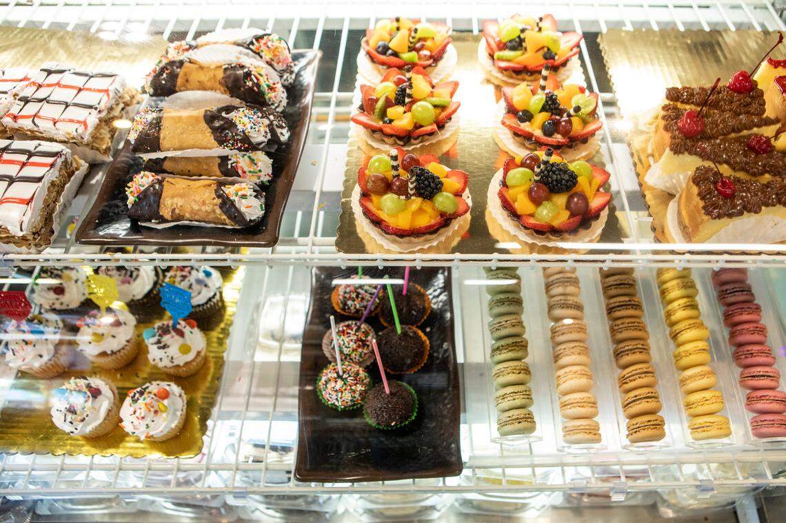 A variety of pastries including cannoli, mini fruit tarts, cheese cake, cupcakes and macarons sit await at Manolo’s Bakery.