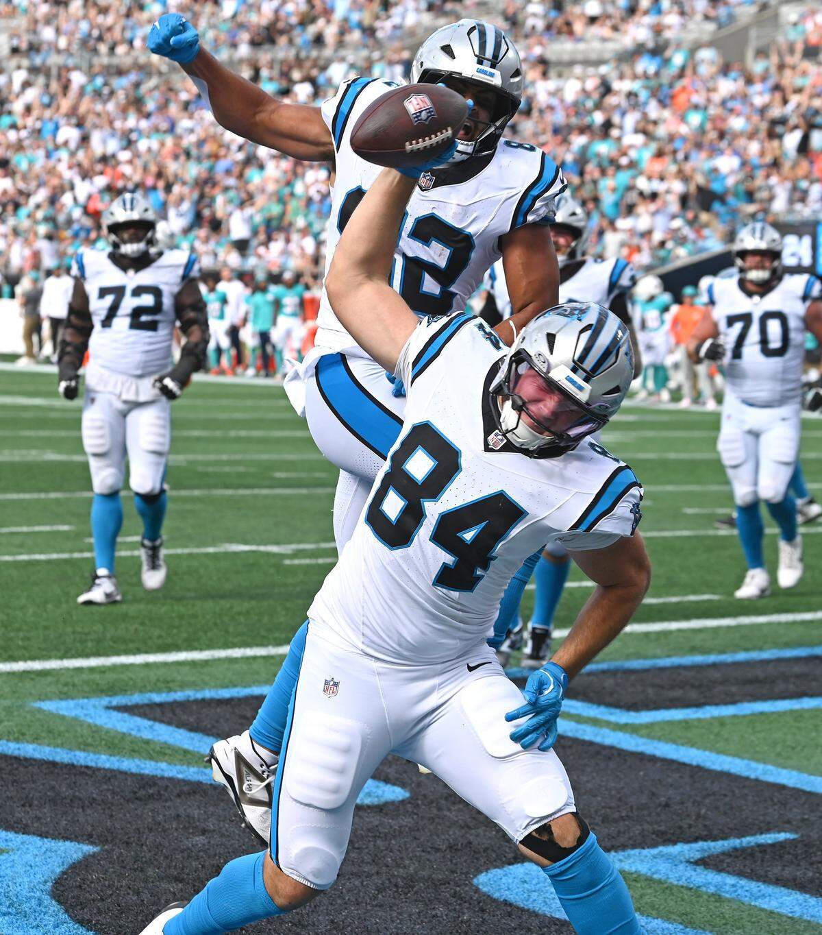 Carolina Panthers tight end Mitchell Evans, center, spikes the football after catching a pass for a touchdown during fourth quarter action against the Miami Dolphins on Sunday, October 5, 2025 at Bank of America Stadium in Charlotte, NC. The Panthers defeated the Dolphins 27-24.