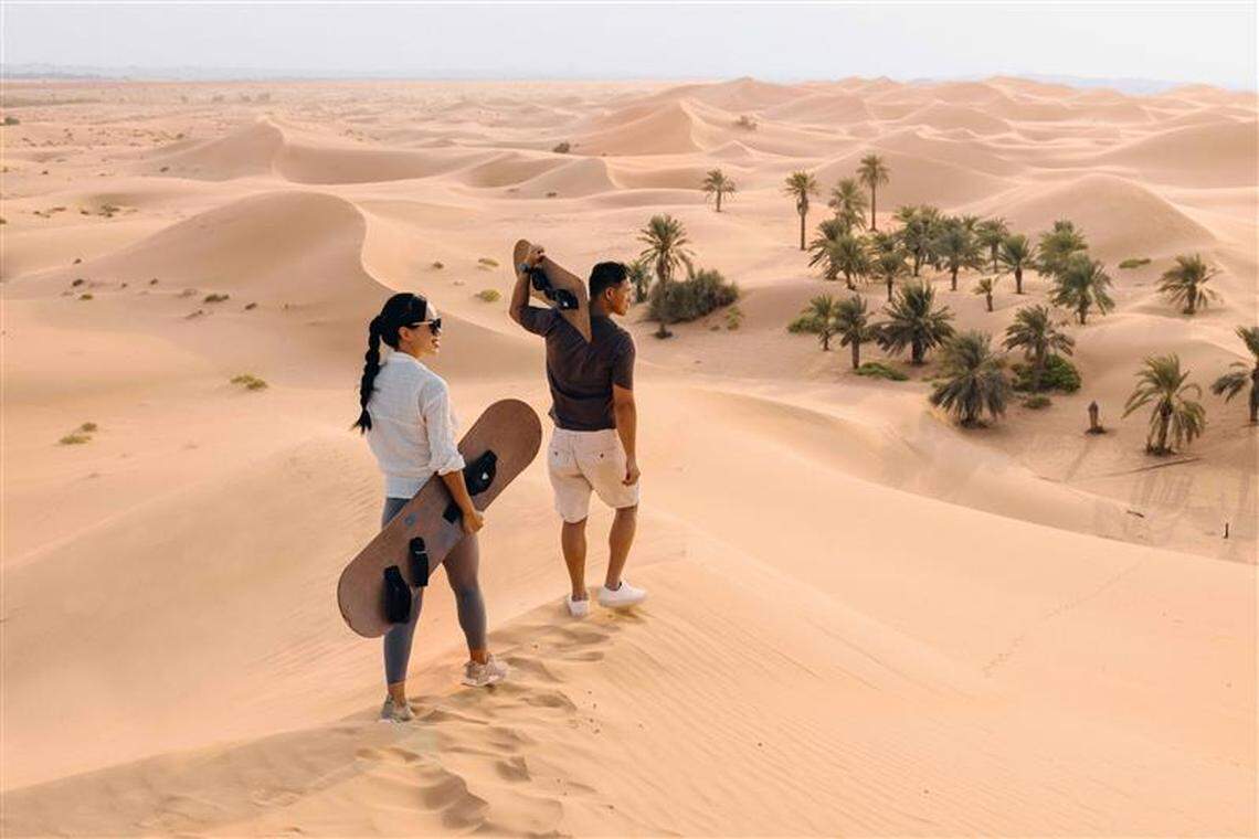 Visitors enjoy sandboarding at the Telal Resort Al Ain in Abu Dhabi, one of many attractions passengers can access when Etihad Airways begins service at Charlotte Douglas International Airport in May 2026.