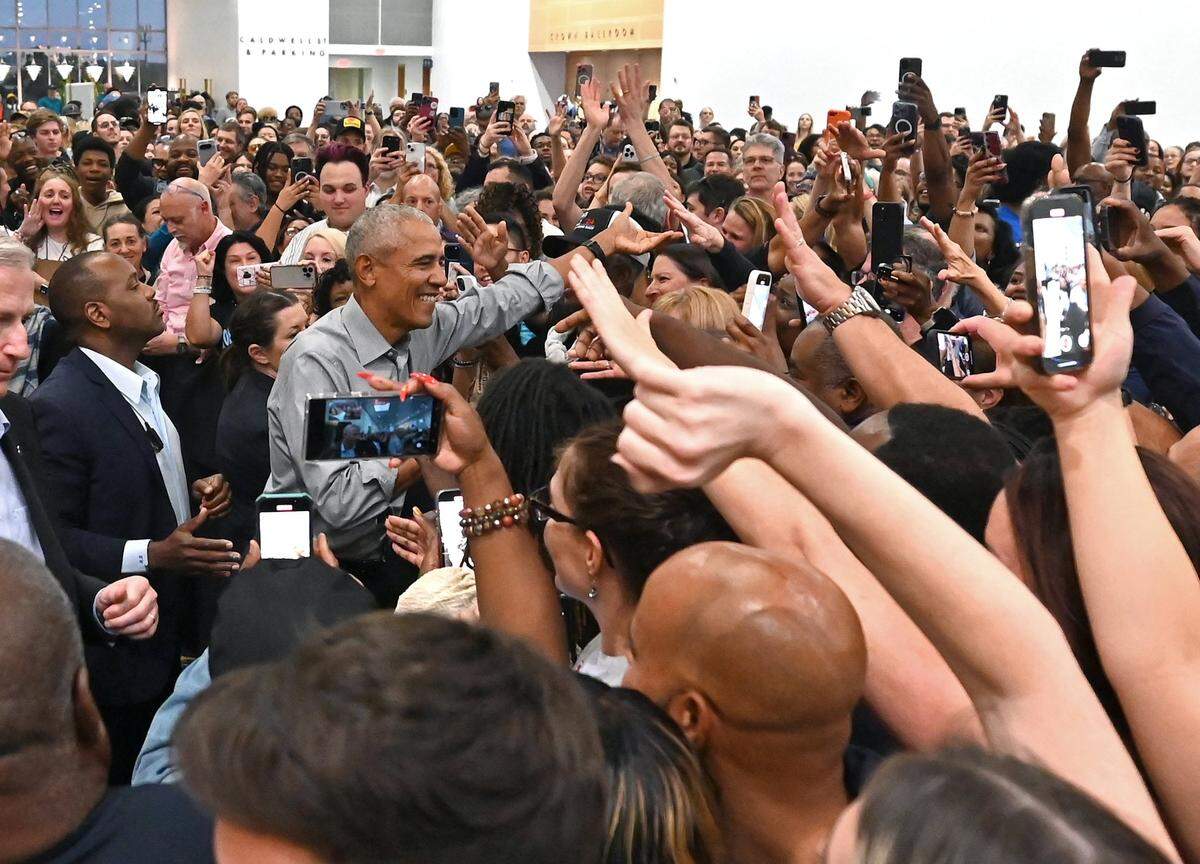 Former President Barack Obama shakes hands in the overflow area at the Charlotte Convention Center on Friday, October 25, 2024.