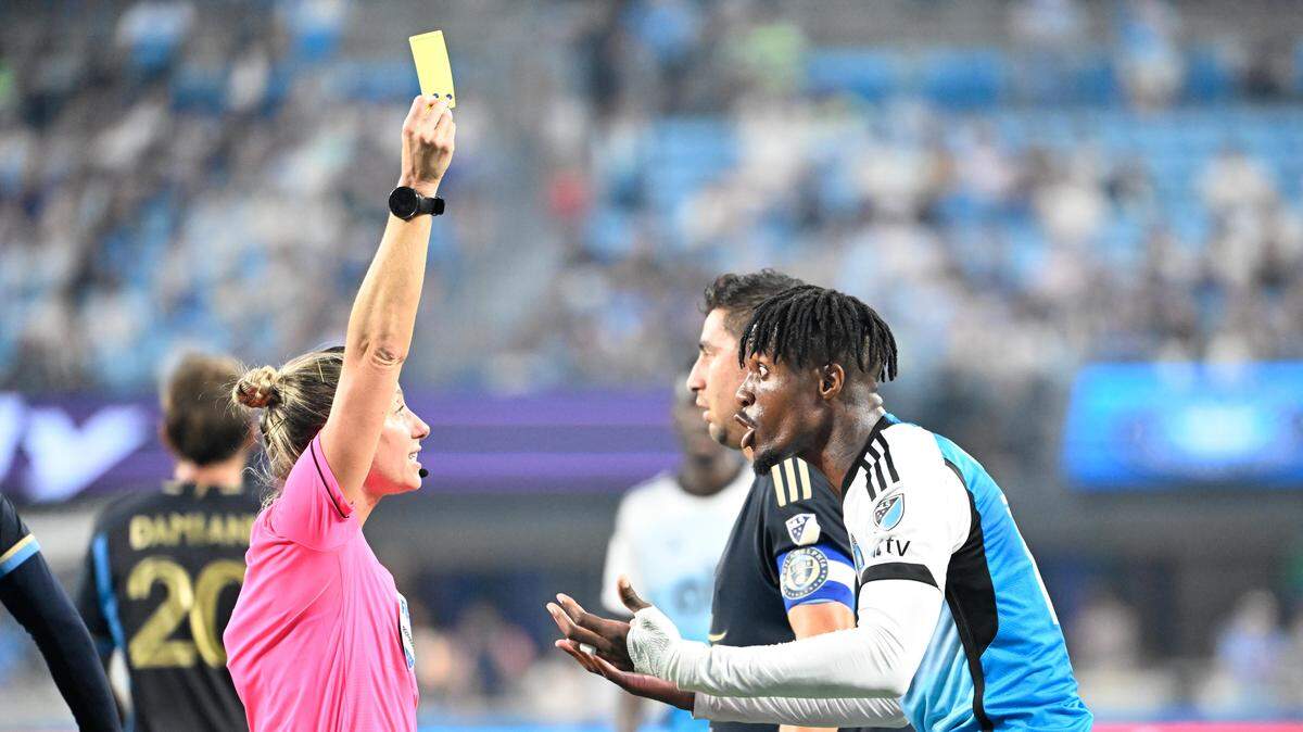 Oct 18, 2025; Charlotte, North Carolina, USA; Referee Tori Penso gives a yellow card to Charlotte FC forward Wilfried Zaha (10) in the first half at Bank of America Stadium. Mandatory Credit: Bob Donnan-Imagn Images