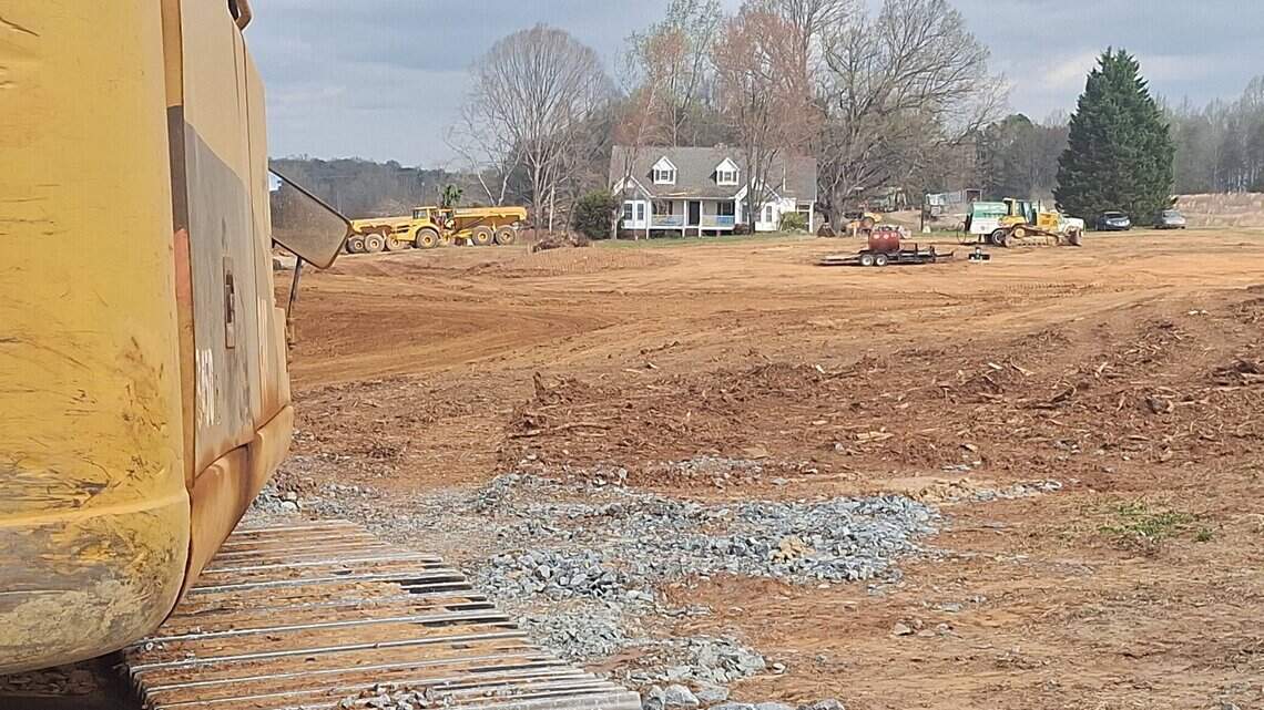 High-end developments rise on narrow, two-lane former country road near Lake Norman
