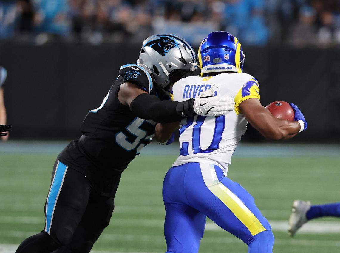 Carolina Panthers Maema Njongmeta attempts to stop Los Angeles Ronnie Rivers during the wild card playoff game against the Rams at Bank of America Stadium on Saturday, Jan. 10, 2025 in Charlotte