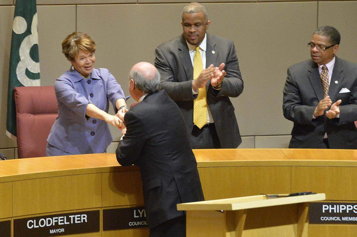 Dan Clodfelter shakes hands with council member Vi Lyles (left)   after taking the oath of office at the Government Center April 09,2014. Dan Clodfelter was sworn in as Charlotte's Mayor,replacing Patrick Cannon, who resigned nearly two weeks ago after his arrest on federal corruption charges, 