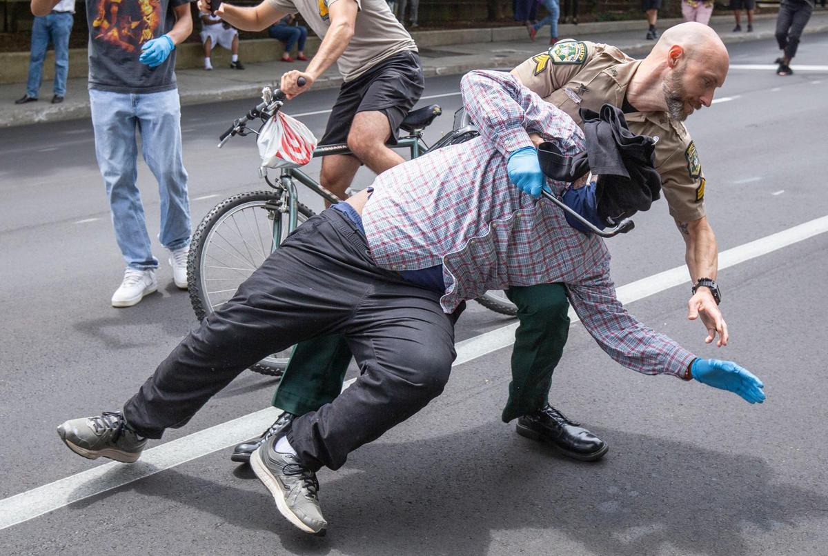 A Mecklenburg County Sheriff officer apprehends a protesters who was holding a tire iron as demonstrators clash with law enforcement in Charlotte, NC on Thursday, June 18, 2020. Sheriff Gary McFadden instructed the jail support station outside the county jail to disperse by 2 p.m. The support group handed out supplies and help get transportation to those who just left jail. The group had been there in some form for the past two weeks around the clock.