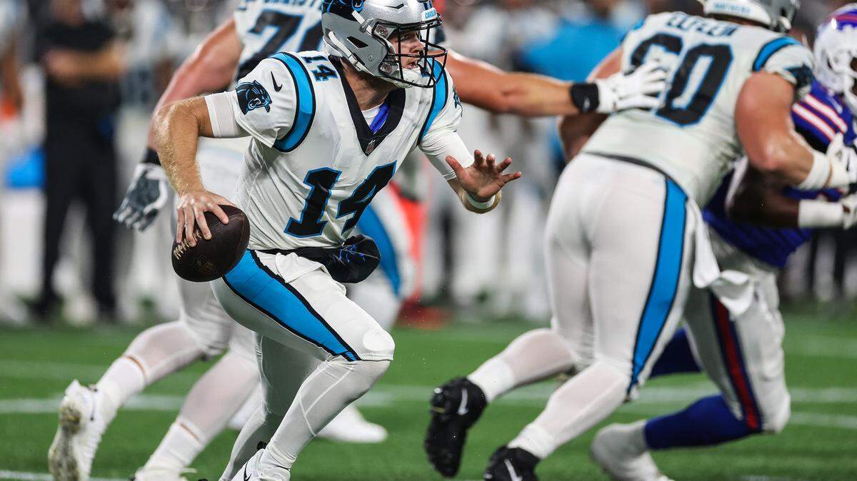 Panthers quarterback Sam Darnold, left, scrambles during the game against the Bills at Bank of America Stadium on Friday, August 26, 2022 in Charlotte, NC.