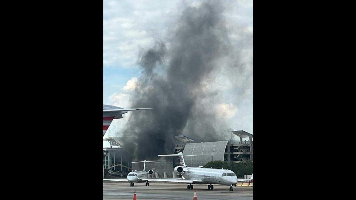 Emily Rose took this picture from the E concourse ramp of the smoke billowing from a fire in the hourly parking deck at Charlotte Douglas International Airport on Saturday, Aug. 10, 2024.