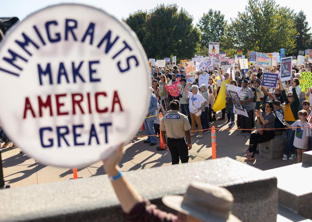 Protesters gather for the No Kings protest in uptown Charlotte on Saturday, October 18, 2025.