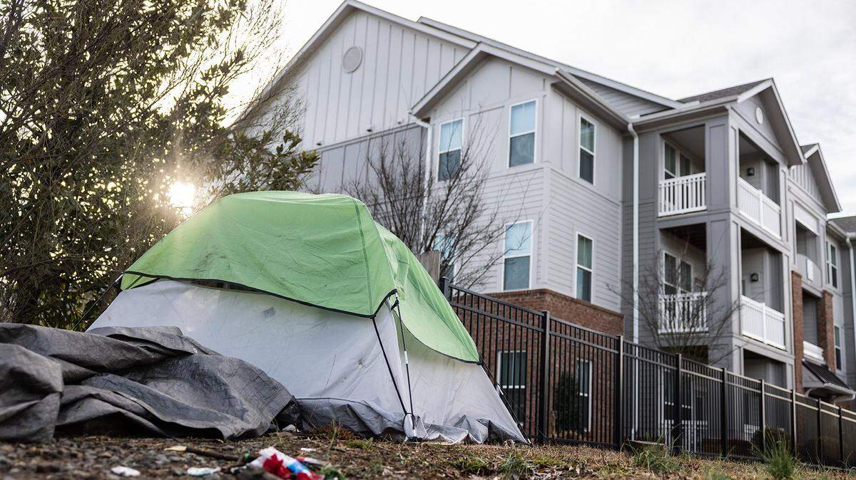 A lot is occupied by unhoused people living in tents on Sugar Creek Road in Charlotte on Friday,February 10, 2023.