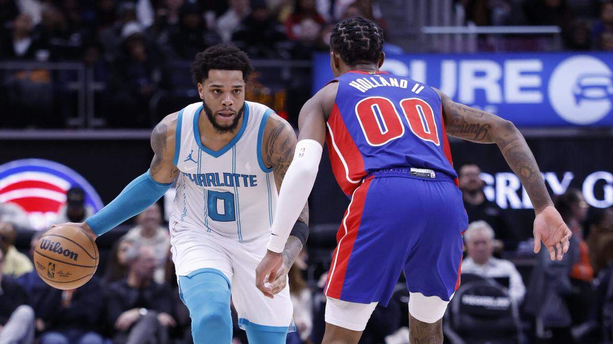 Charlotte Hornets forward Miles Bridges (0) dribbles against Detroit Pistons forward Ronald Holland II (00) in the first half at Little Caesars Arena.
