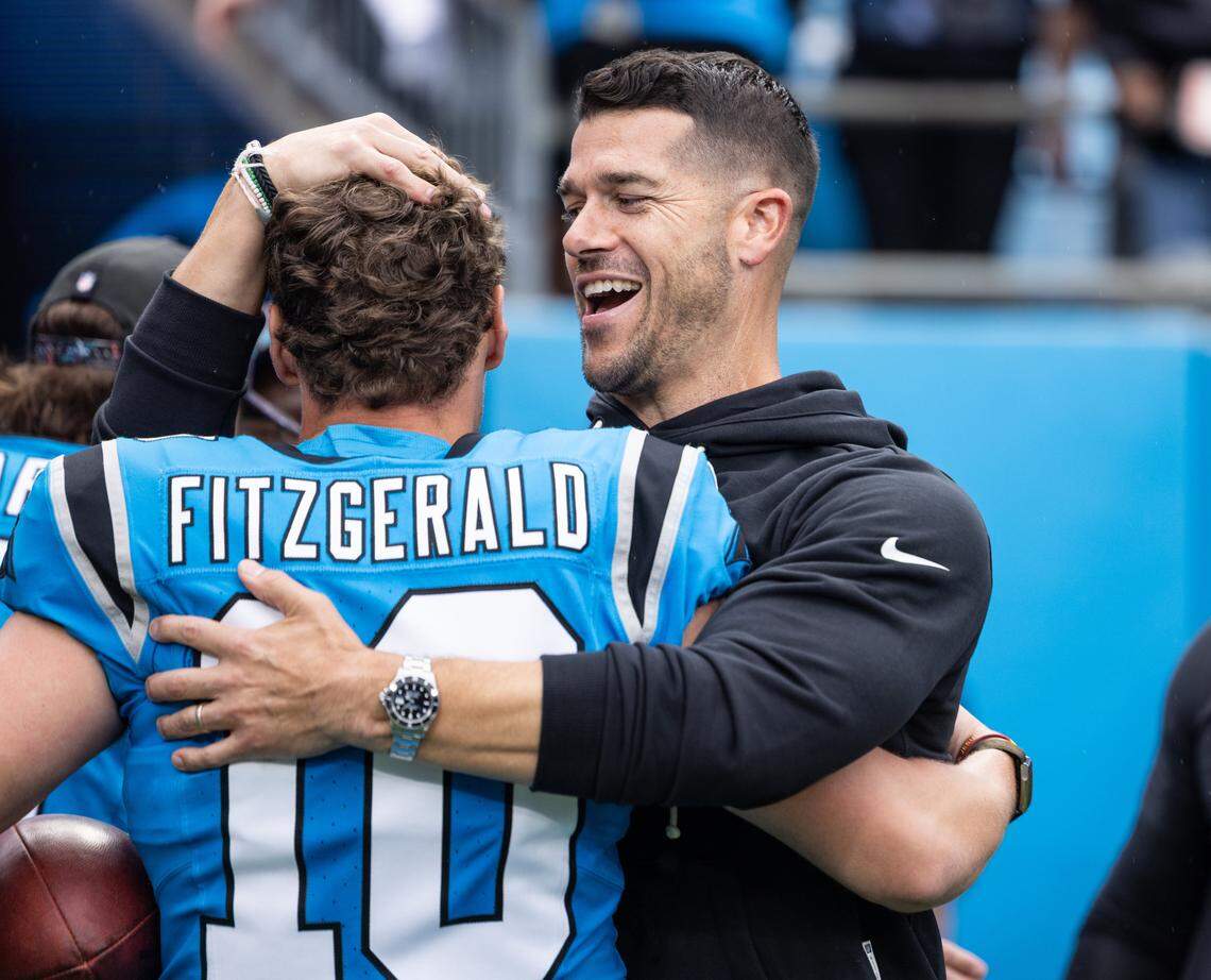 Carolina Panthers coach Dave Canales gives Carolina Panthers kicker Ryan Fitzgerald a hug after his game winning kick at the Bank of America Stadium in Charlotte, N.C., on Sunday, October 12, 2025.