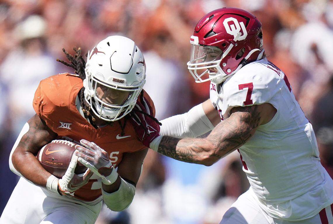 Texas Longhorns running back Jonathon Brooks (24) fights for yardage against Oklahoma Sooners linebacker Jaren Kanak (7) in a 2023 game.