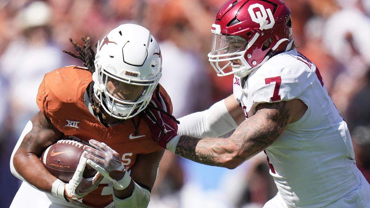 Texas Longhorns running back Jonathon Brooks (24) fights for yardage against Oklahoma Sooners linebacker Jaren Kanak (7) in a 2023 game. Ricardo B. Brazziell / Austin American-Statesman