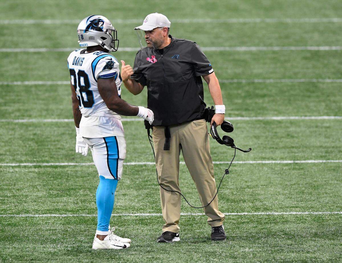 Carolina Panthers head coach Matt Rhule talks with running back Mike Davis (28) during a timeout Sunday. Davis had 89 yards rushing and 60 yards receiving in the Panthers’ 23-16 win over Atlanta.
