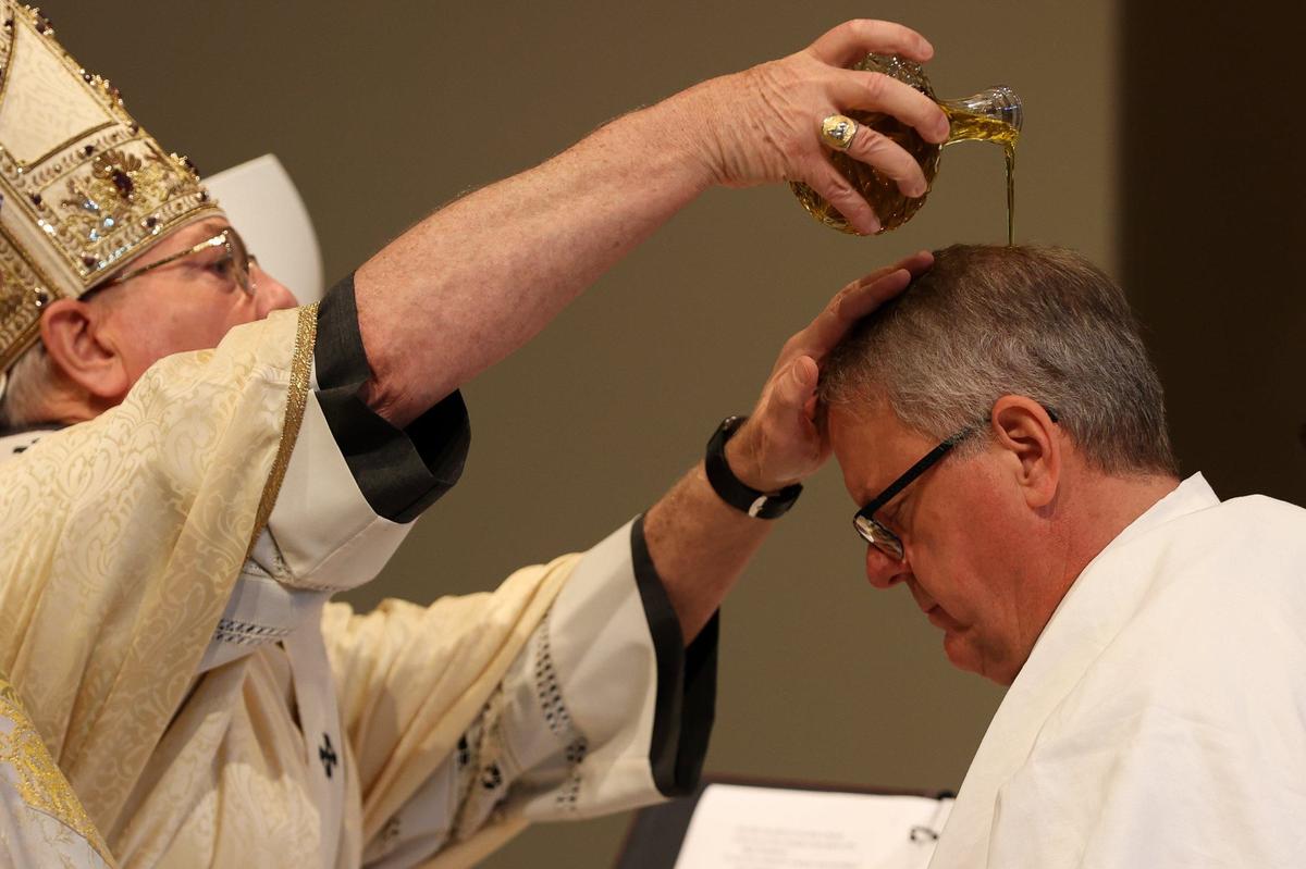 Bishop Michael T. Martin is anointed with sacred chrism by Archbishop Gregory Hartmayer of Atlanta at Saint Mark Catholic Church in Huntersville on Wednesday.