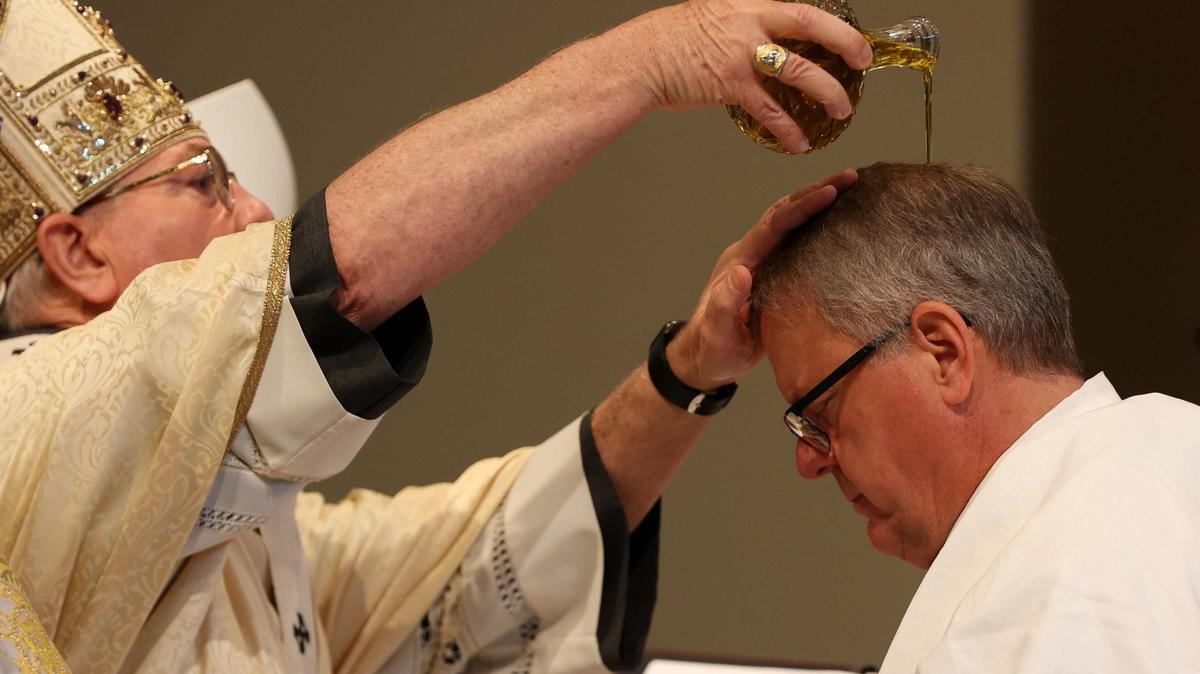 Bishop Michael T. Martin is anointed with sacred chrism by Archbishop Gregory Hartmayer of Atlanta at Saint Mark Catholic Church in Huntersville on Wednesday.