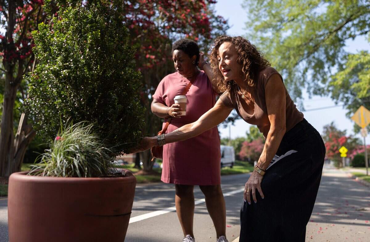 Tanya Wilson, left, and Valerie Preston, point out issues with the planters along The Plaza in the Plaza Midwood neighborhood in Charlotte, N.C., on Tuesday, June 29, 2026.