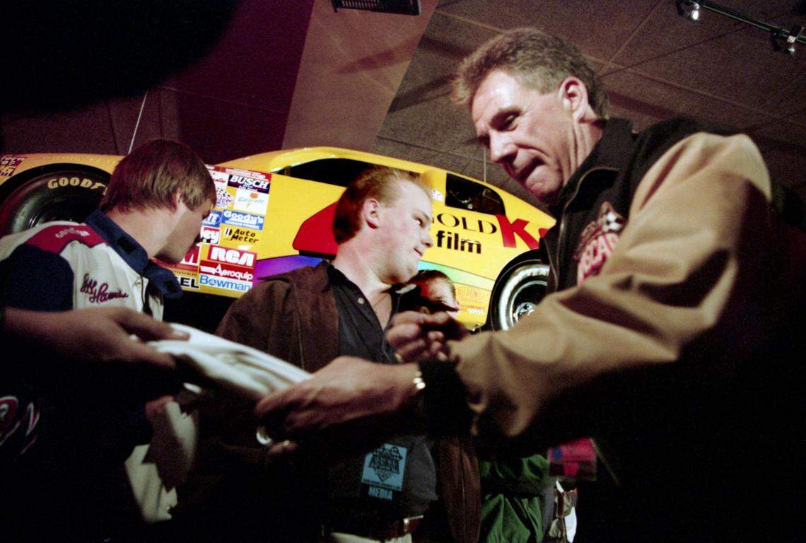 NASCAR driver Darrell Waltrip, right, of Franklin, Tenn., signs his autograph for fans during the grand opening of the NASCAR Café theme restaurant on Lower Broadway Nov. 11, 1997.